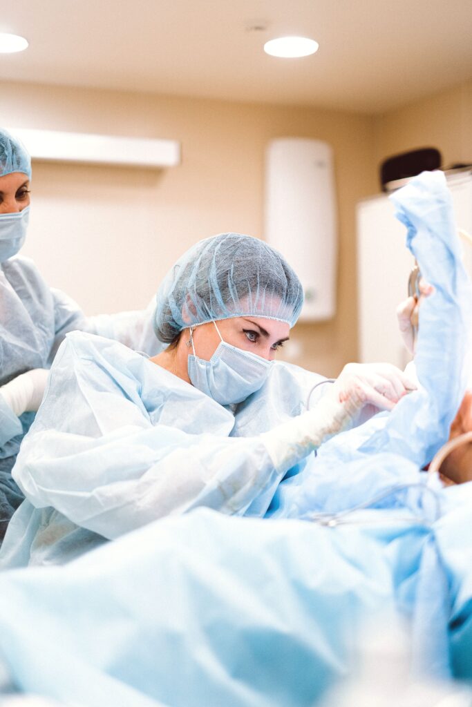 Focused female surgeon conducting a delicate procedure in the operating room.