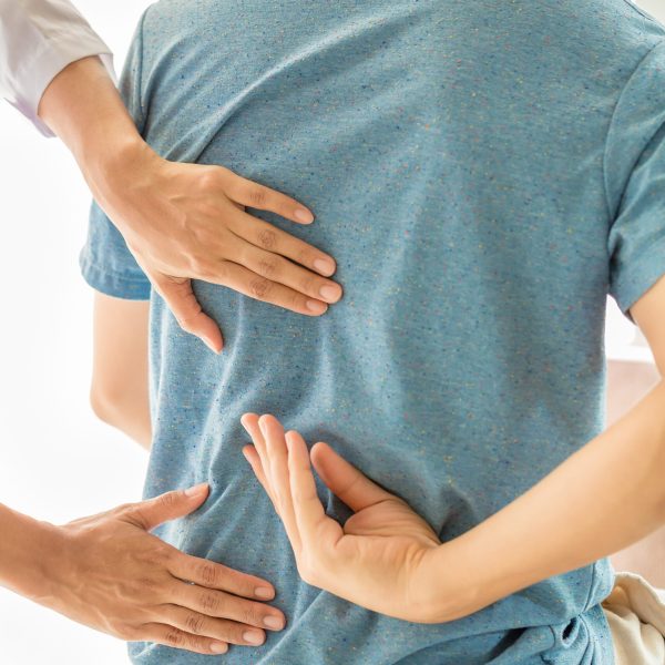 Physical therapists are examining the patient's body.